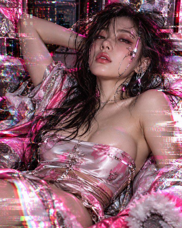 Reclining model in pink satin with glitch effects, wet dark hair and delicate chain face jewelry