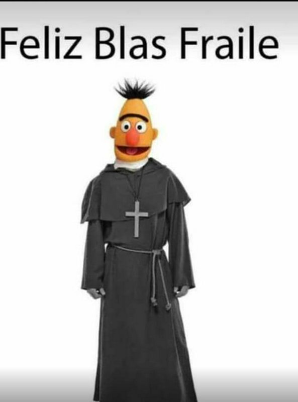 Muppet-style puppet dressed in a black monk robe with a silver cross necklace.