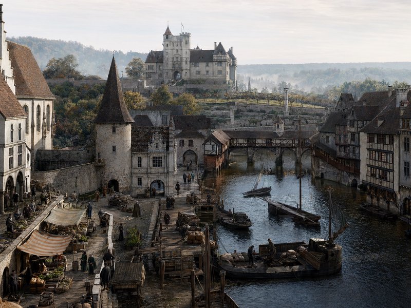Medieval European riverside town with a castle, timber-framed houses, market stalls, and a stone ...
