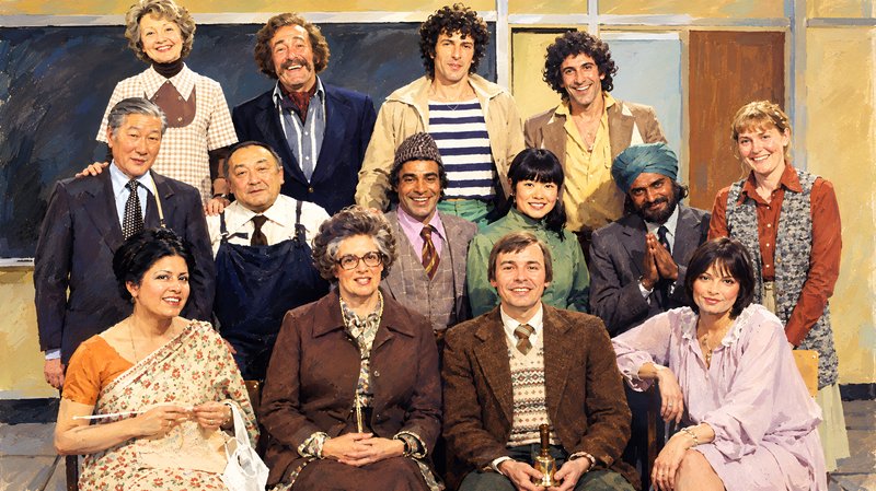 Full cast of classic 1970s British sitcom Mind Your Language posing together on a classroom set