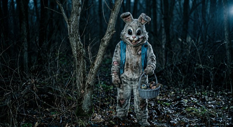 A eerie, life-sized rabbit costume stands in a dim | pajmeravilla on ...