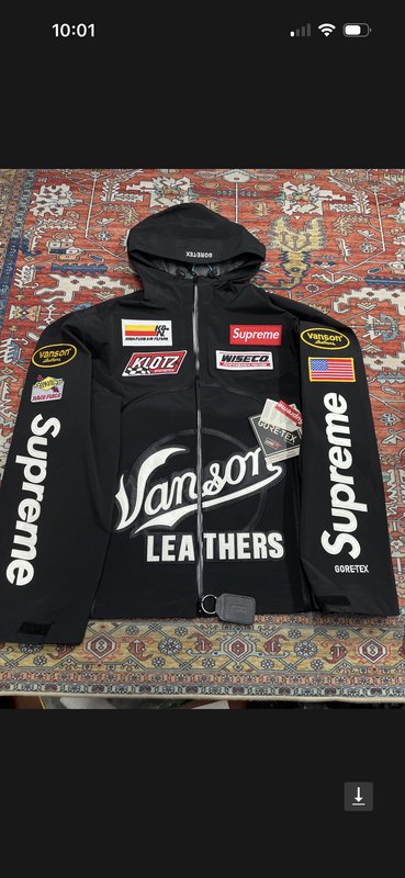Black Supreme x Vanson Leathers GORE-TEX hooded racing jacket laid flat on an ornate patterned ar...