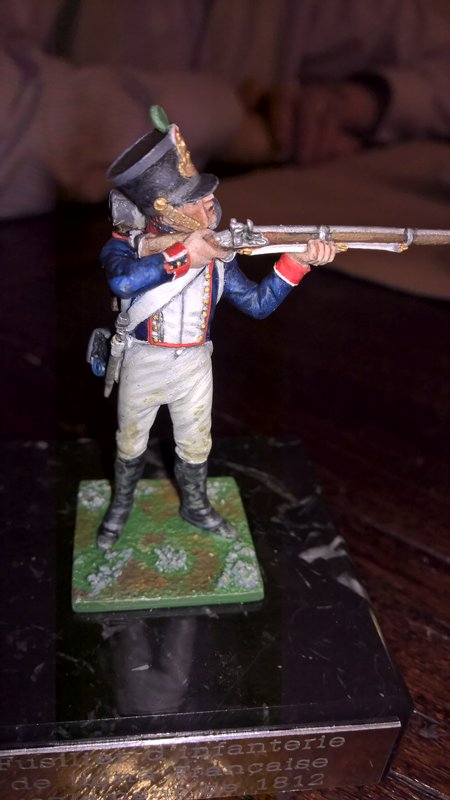 Painted Napoleonic-era musketeer figurine aiming a flintlock musket