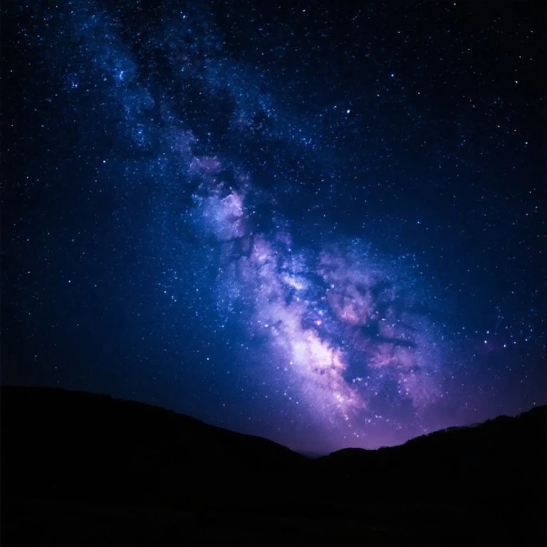Swirling purple and blue Milky Way galaxy above dark silhouetted mountain ridges on a clear starr...