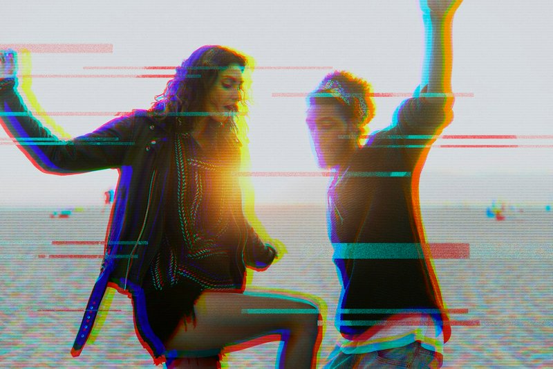 Two people on a beach dancing with a colorful glitch art effect and horizon in the background.