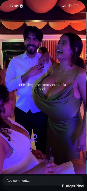 Wedding reception moment with a joyful couple dancing under colorful lights.