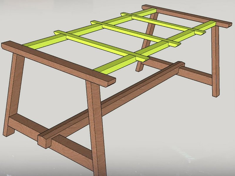 Wooden sawhorse-style workbench with lime-green lattice top slats.