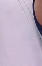 Close-up of white fabric with blue trim and a hint of skin.