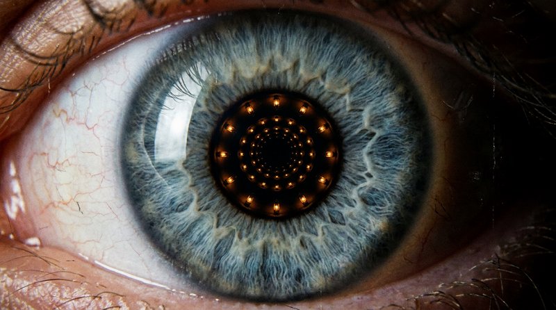 Close-up blue eye with a tunnel-like concentric pattern in the pupil.