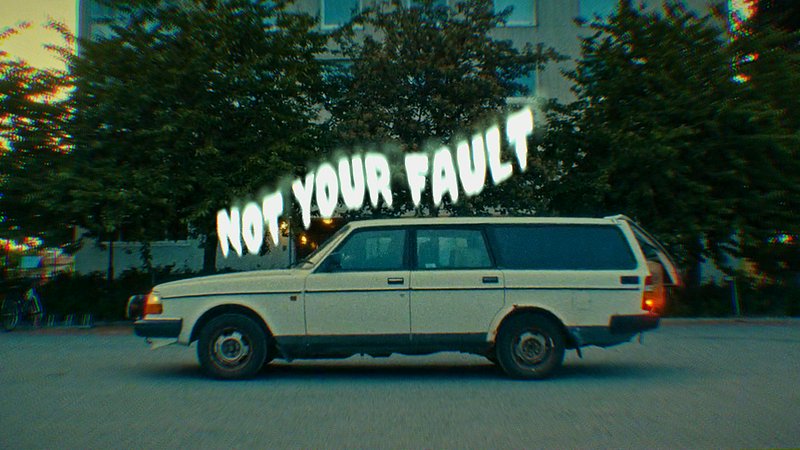 White vintage van with a neon-style "NOT YOUR FAULT" text overlay