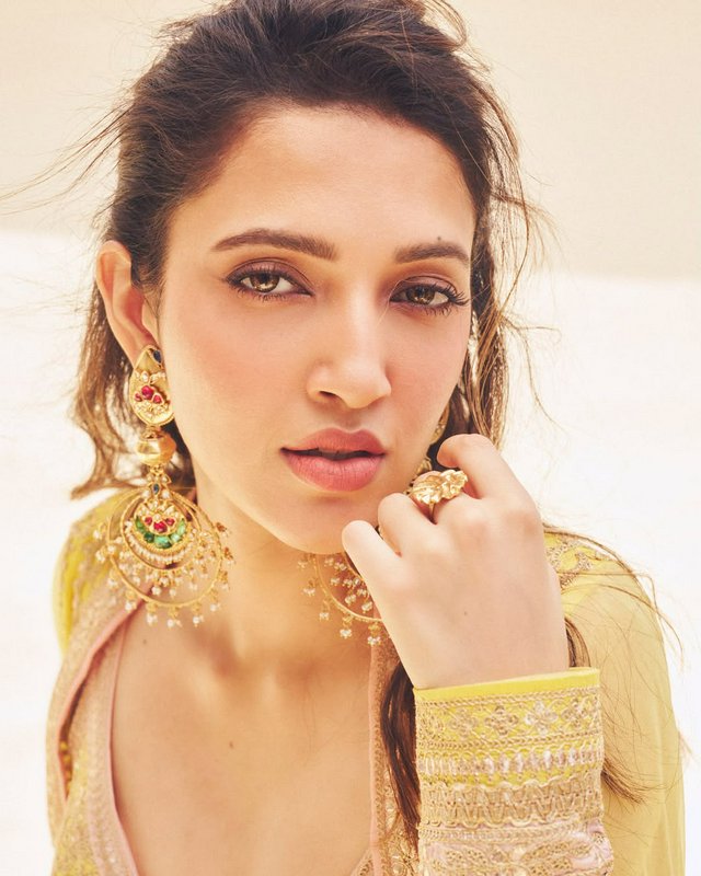Portrait of a woman in ornate gold jewelry and traditional attire.
