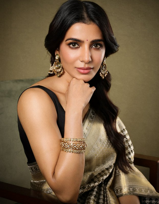 South Indian actress Samantha Ruth Prabhu poses in a silk saree with gold jewelry, resting her ch...