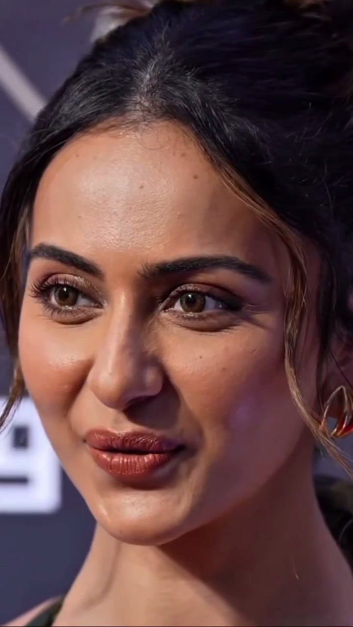 Close-up portrait of Bollywood actress Rakul Preet Singh with glowy makeup, pulled-back hair, and...