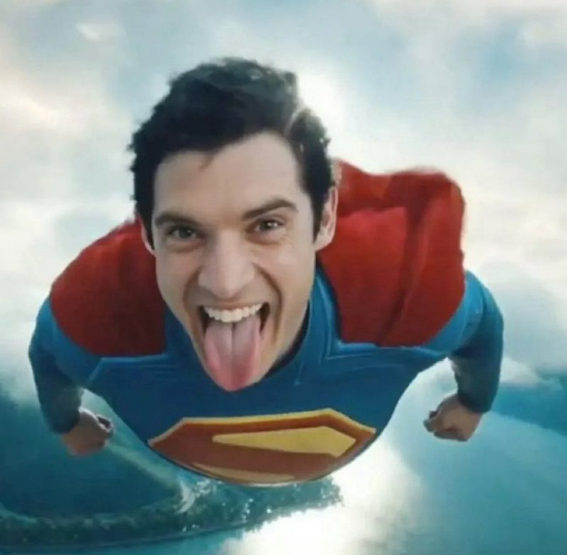 Goofy playful Superman sticks his tongue out while flying directly toward the camera above bright...