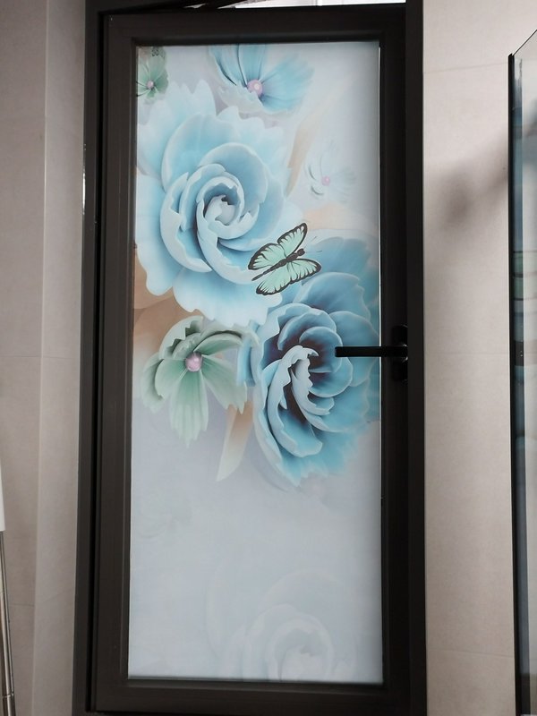 Frosted glass door featuring blue roses and a butterfly design.