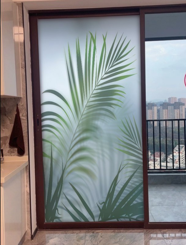 Frosted glass sliding door with large tropical palm leaf design