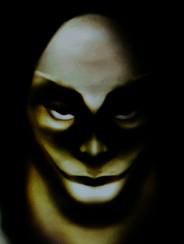 Dark hooded figure with a pale, sinister face emerging from shadows.