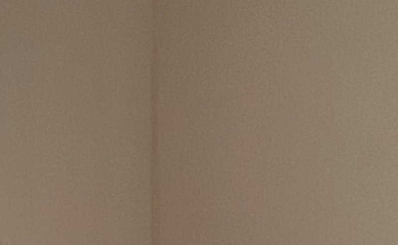 Beige interior wall corner with subtle texture and soft lighting