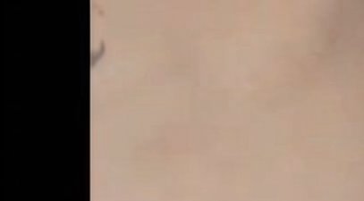 Heavily blurred close-up of light beige human skin with a solid black vertical border along the l...