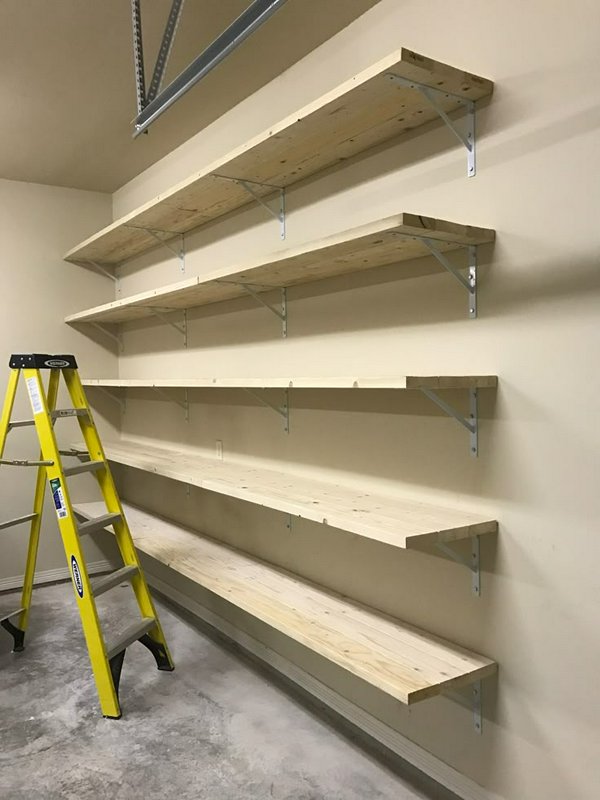 Wooden wall-mounted shelves with metal brackets and a yellow ladder in a garage.