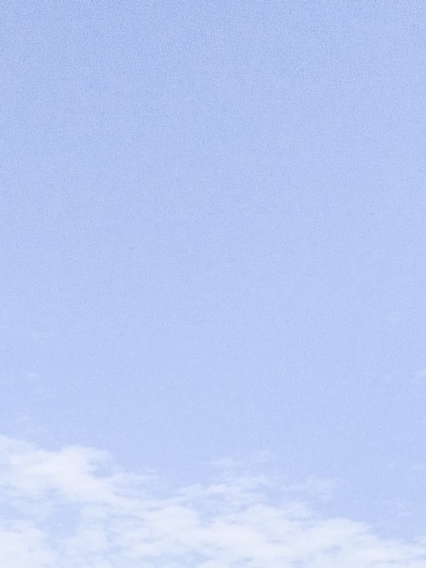 Blue sky with a few wispy white clouds at the horizon.
