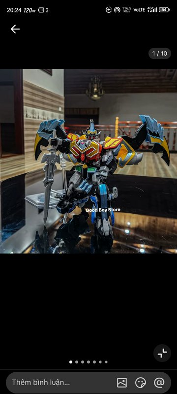 Colorful megazord-style action figure with wings and sword on a glossy surface