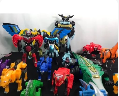 Colorful collection of Power Rangers zord action figures, including assembled megazords and indiv...