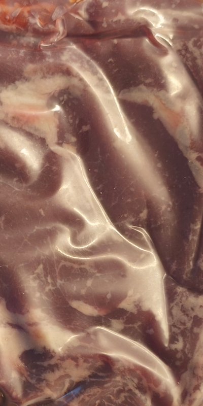 Close-up glossy abstract marbled texture, swirling dark brown, cream, and warm pale orange flowing organic patterns