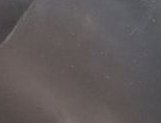 Soft blurred abstract background in muted taupe and dusty gray, with a faint curved edge in the upper left corner.