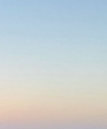 Soft textured vertical gradient transitioning from pale sky blue at the top to warm pastel peach ...