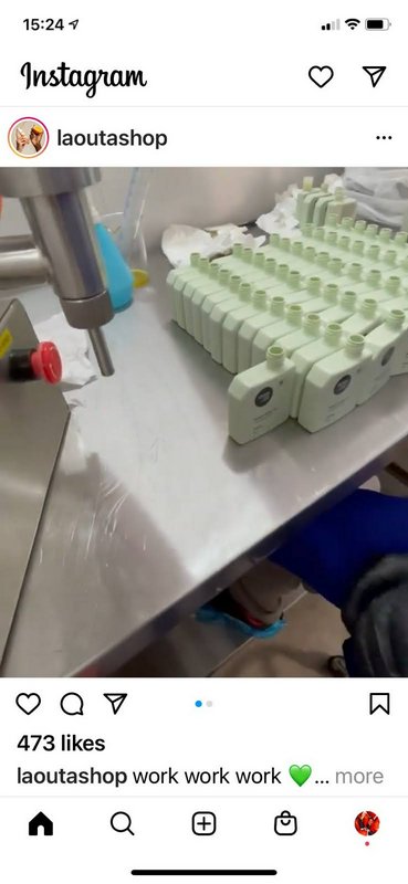 Instagram post showing rows of pale green empty product bottles next to filling equipment on a st...