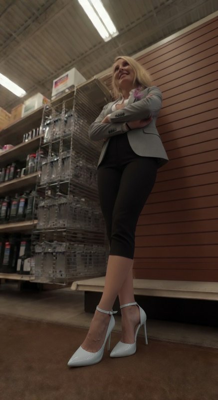 Woman in blazer and white high heels stands confidently in a store aisle with arms crossed.