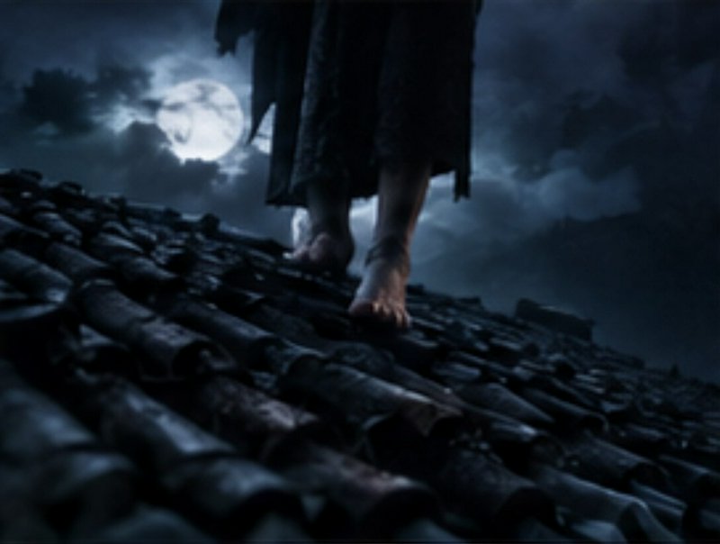 Barefoot robed figure walks across a weathered tiled rooftop under a glowing full moon at night