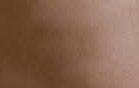 Close-up of warm brown skin texture with subtle highlights