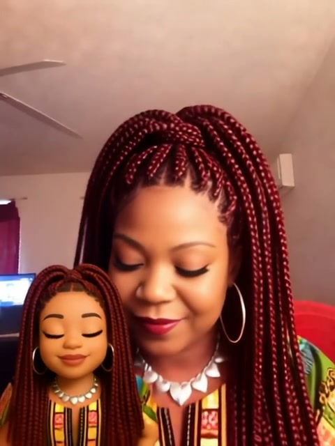 Black woman holding a custom lookalike doll with identical burgundy box braids, matching outfits ...
