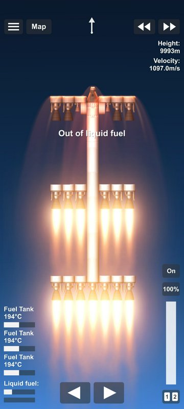 Vertical rocket engine cluster expelling bright flames with “Out of liquid fuel” message on dark ...