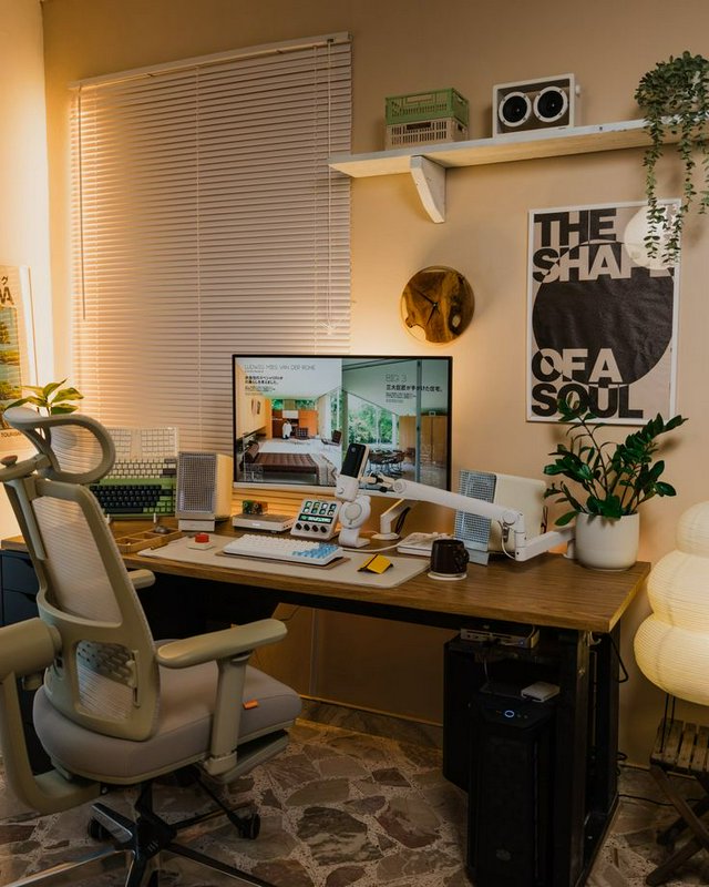 Cozy warm minimalist home office desk setup with ergonomic chair, tech accessories, potted plants...