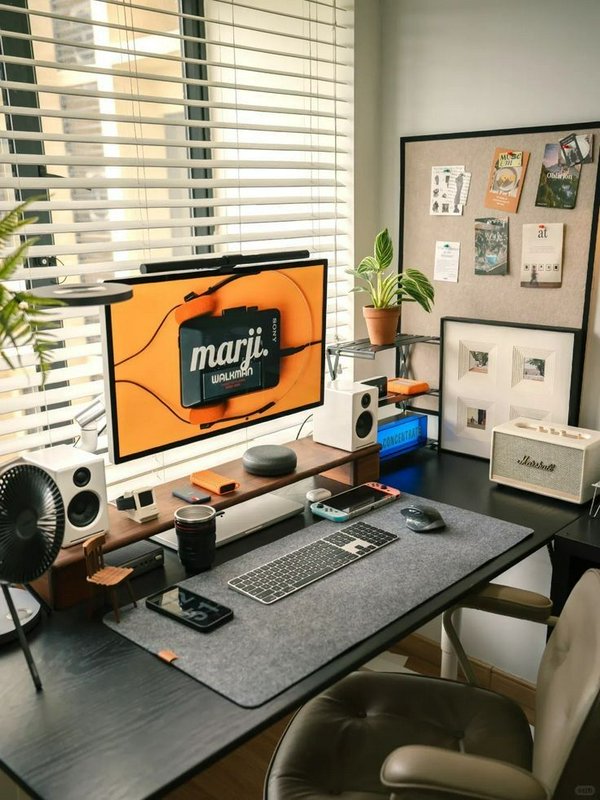 Curated cozy modern home office desk setup with tech, potted plants, and soft natural window light
