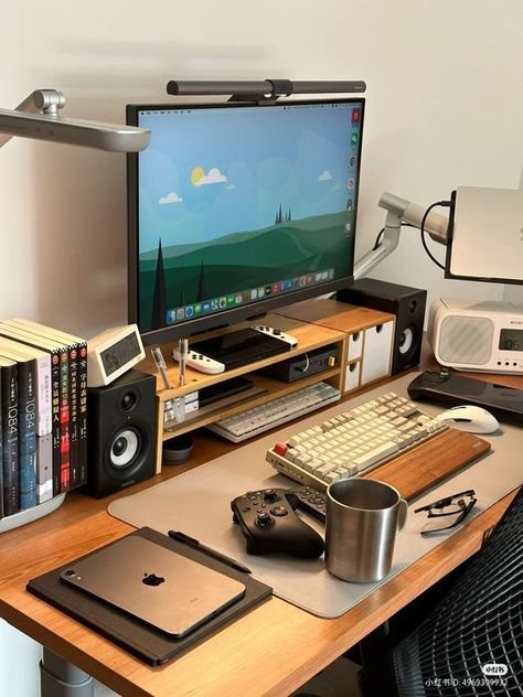 Neat organized minimalist wooden home office desk with monitor, mechanical keyboard, gaming gear,...