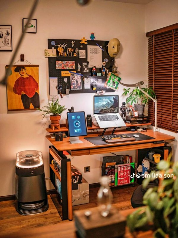 Warm cozy home office featuring a wooden standing desk, potted houseplants, collectible figurines...