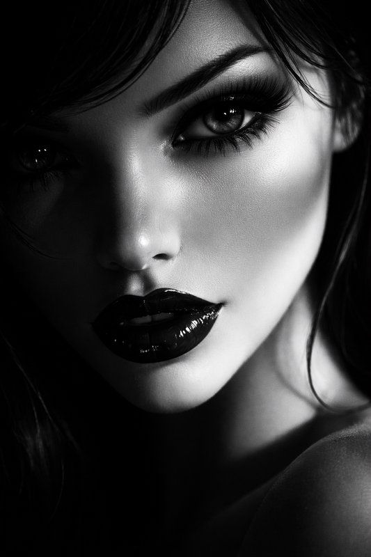 Close-up black-and-white portrait of a woman with dramatic makeup and glossy lips.