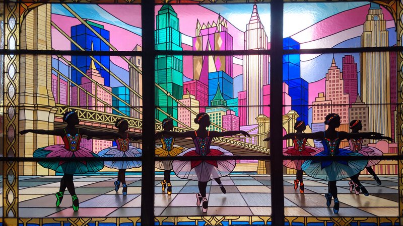 in Mosaic, cut glass, art-deco stained glass illustration of a group of ballet dancers performing in front of a colorful cityscape. the dancers are wearing colorful tutus and pointe shoes, and they are in a line, with their arms stretched out to the sides. the background is filled with a variety of geometric shapes and colors, including triangles, squares, and rectangles in shades of pink, blue, green, and gold. the cityscape behind the dancers is made up of tall buildings and skyscrapers, and there is a bridge in the foreground. the overall mood of the image is vibrant and lively, with a sense of movement and energy.