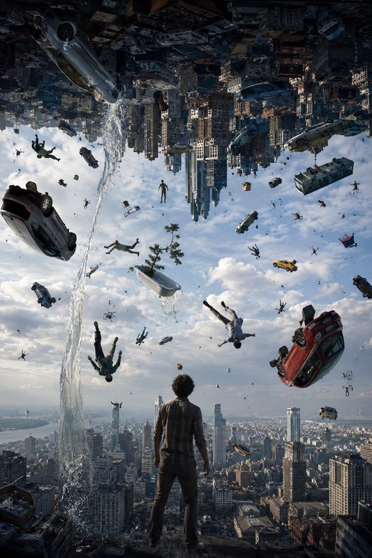 A man stands overlooking a surreal inverted city as cars, people, and debris fall through a cloudy skyscape