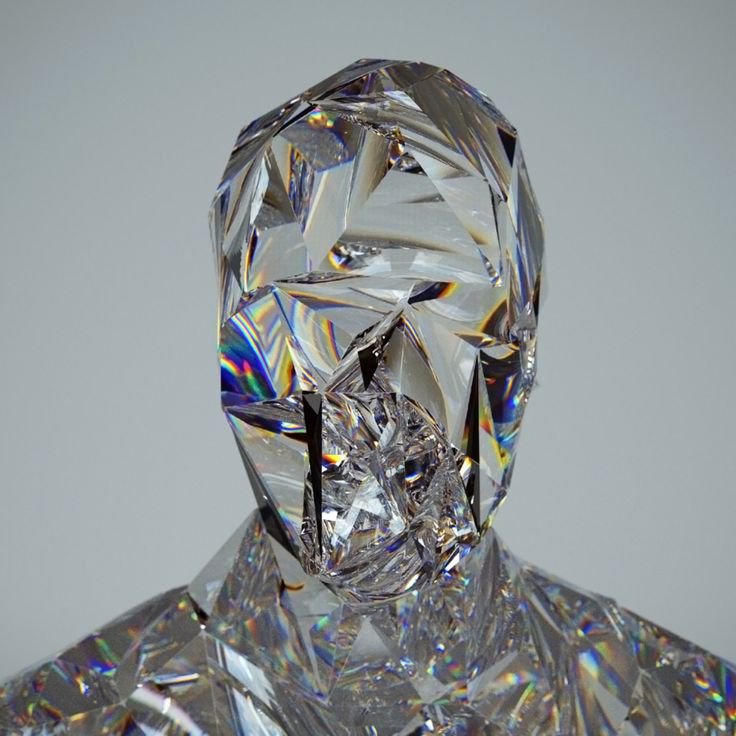 Faceted transparent crystal human head bust with sharp geometric cut facets refracting rainbow li...