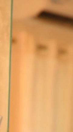 Close-up of a glass edge with a blurred warm amber background.