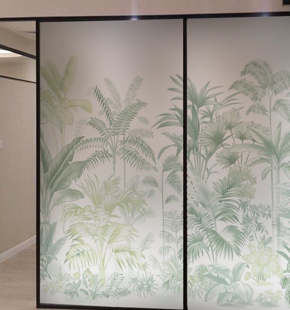 Frosted glass room divider featuring green tropical plant silhouettes.