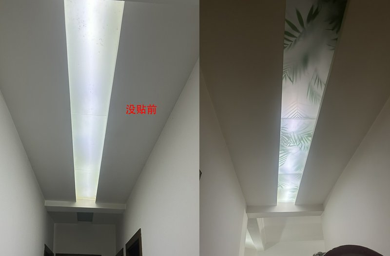 Long white hallway with rectangular skylight panels, one showing a leaf-pattern design