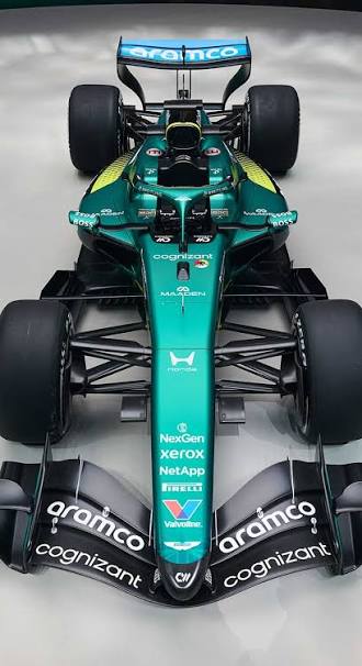 Front view of a green Formula 1 race car with sponsor logos and prominent rear wing.