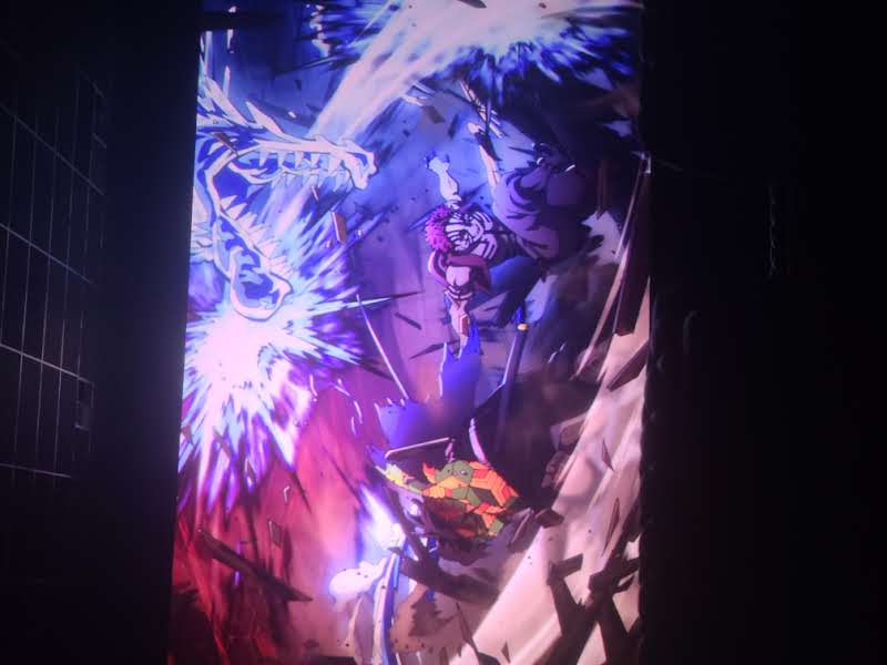 Vertical banner depicting an anime-style battle with a green turtle fighter amid neon energy blas...