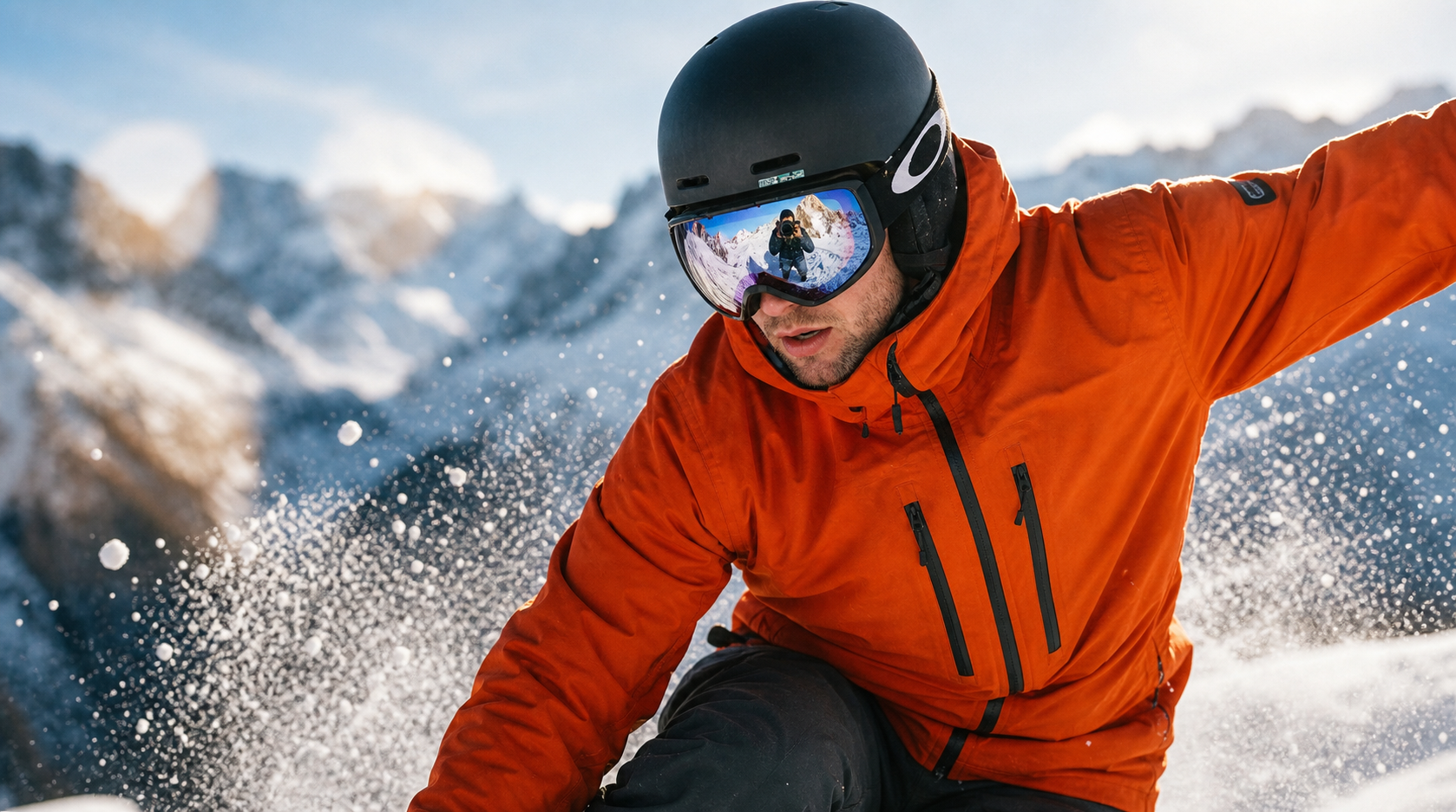 Snowboarder in an orange jacket wearing a black helmet and mirrored goggles carving through powder.